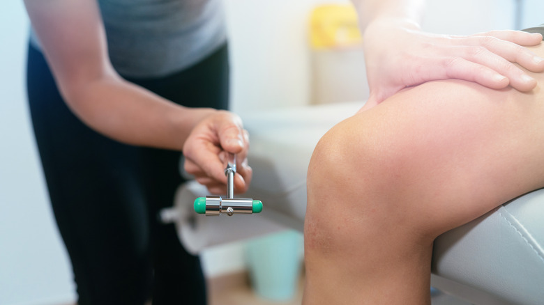 doctor hitting patient's knee