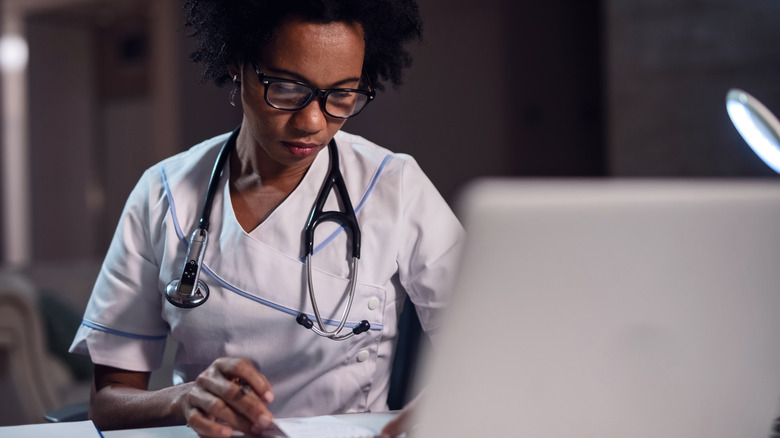 doctor looking at medical record