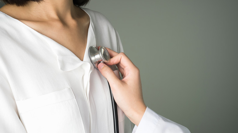 Doctor listening to heart with stethoscope