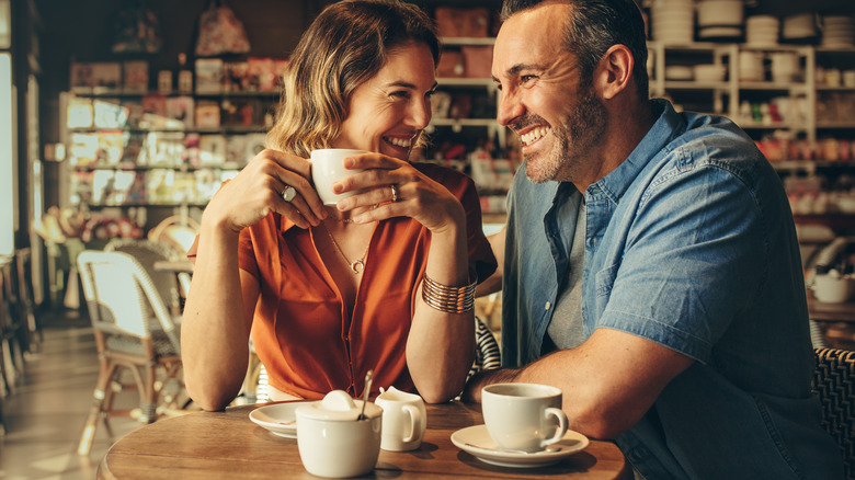 A happy couple drinking coffee together