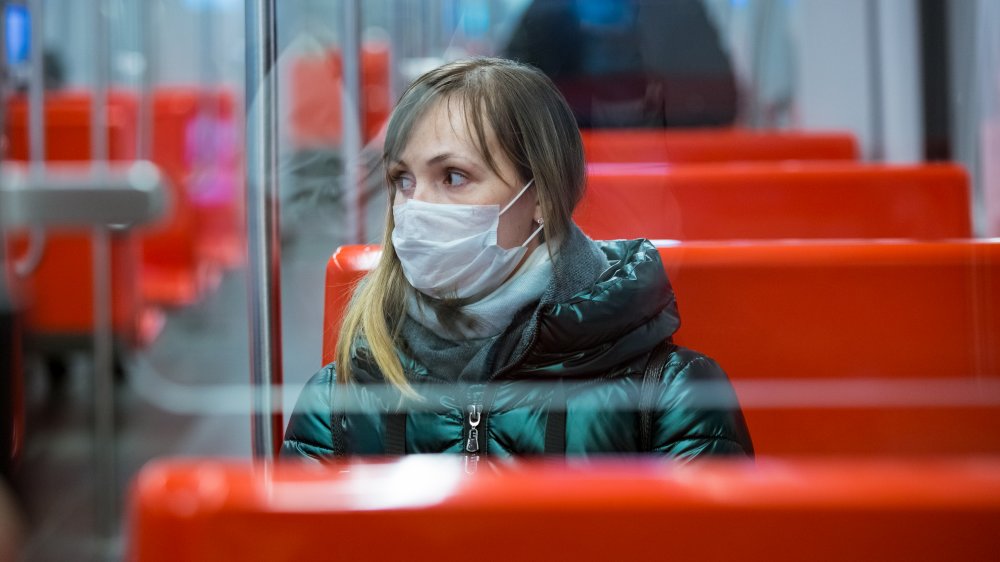 Woman wears a mask on public transit