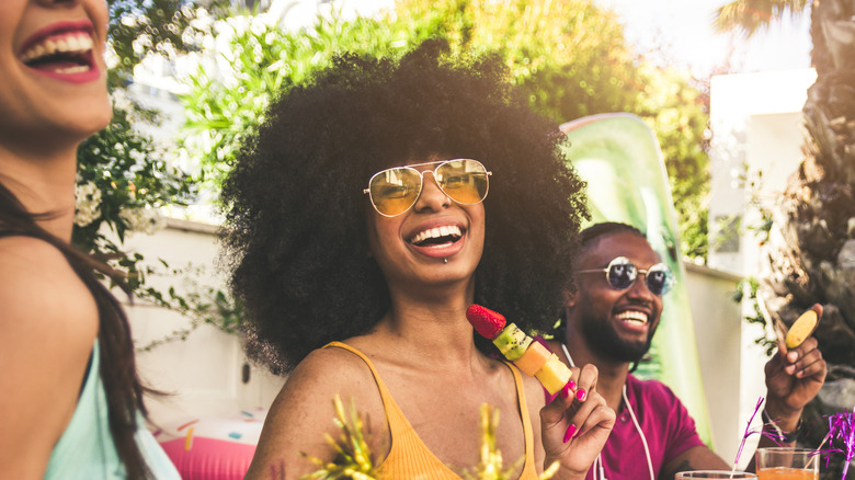 Group of people laughing in backyard