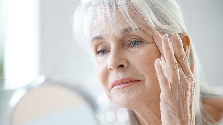 woman looking at wrinkles