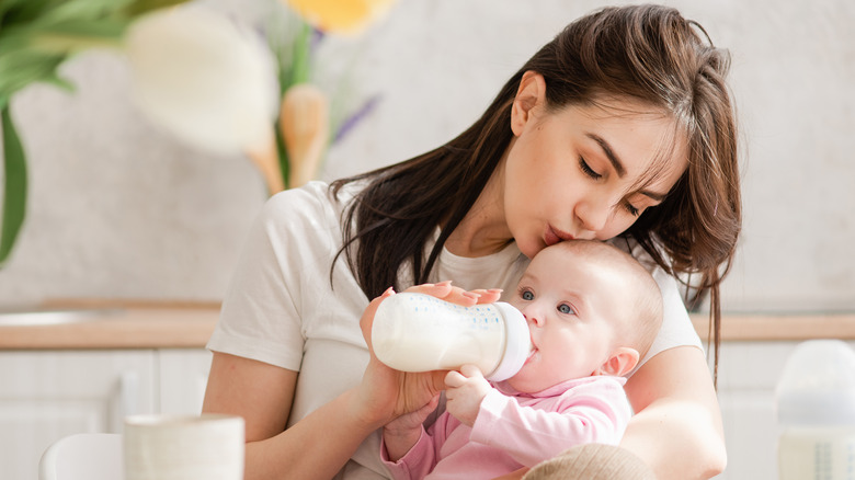 Mother bottle-feeding her baby