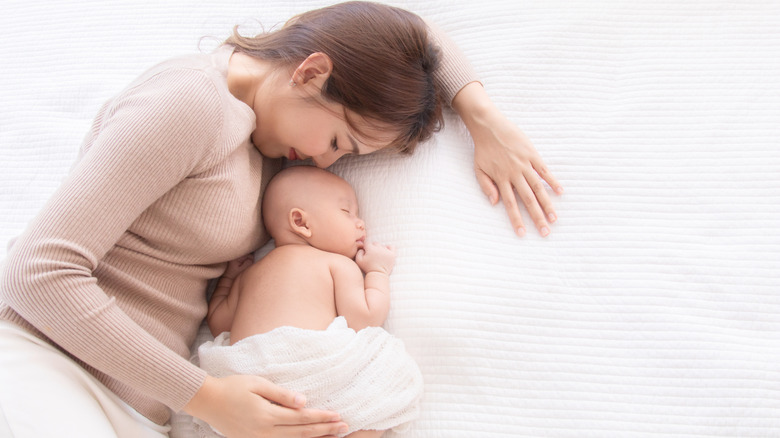 Mother cuddling with baby