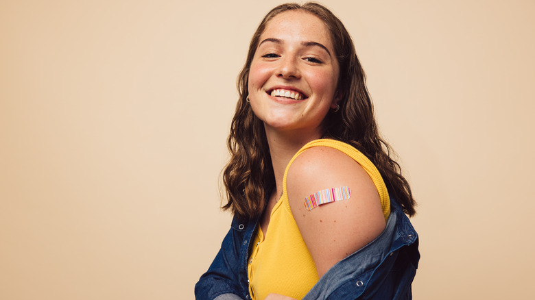 Woman showing her vaccination site