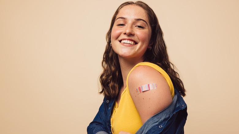 Woman showing her vaccination site