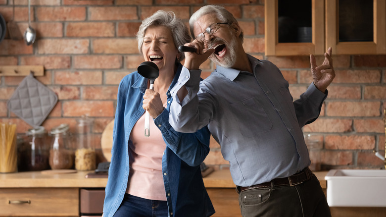 husband and wife singing in the kitchen