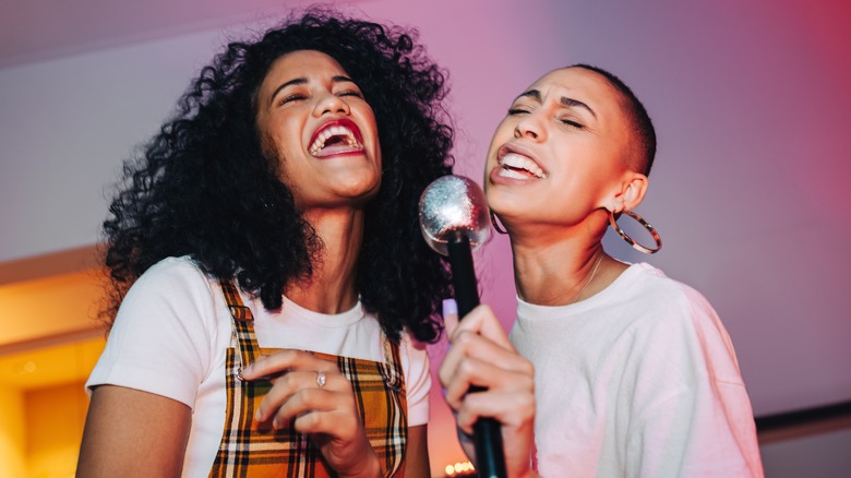 women singing karaoke