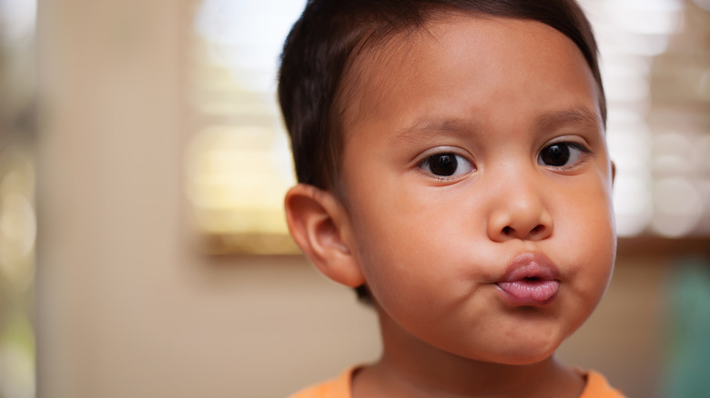 Little boy whistling