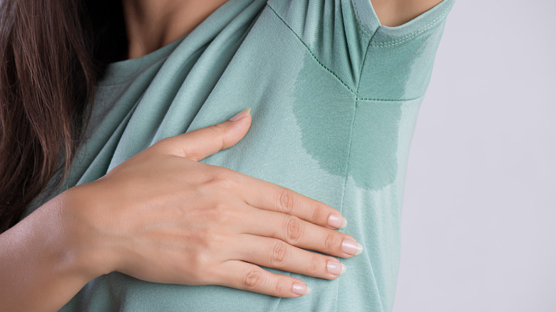 Underarm stain on woman's t-shirt