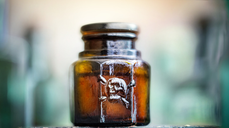 Glass poison bottle with skull and bones