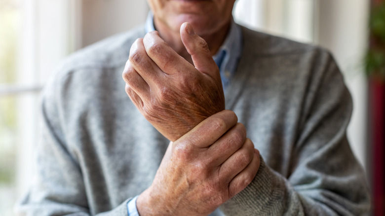 man holding wrist in pain