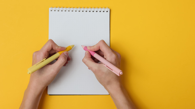 Ambidextrous person writing with both hands