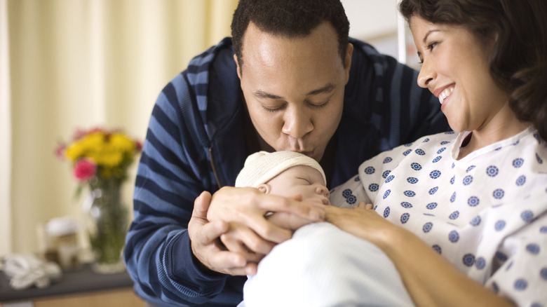 Caring family man kissing child