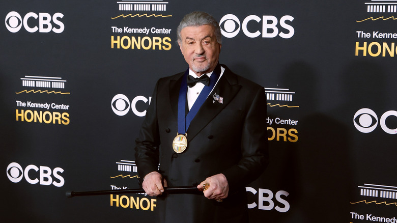 Sylvester Stallone at The Kennedy Center Honors holding a cane