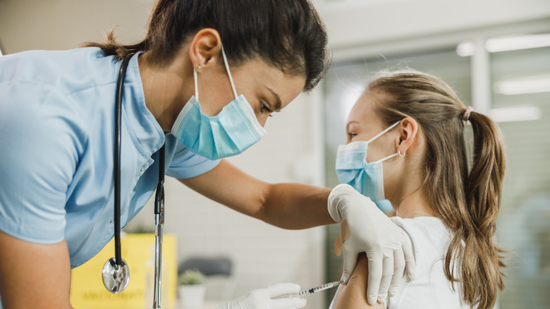 Teenage girl getting covid vaccine