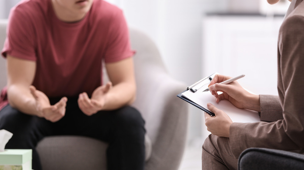 teen boy talking with doctor about symptoms