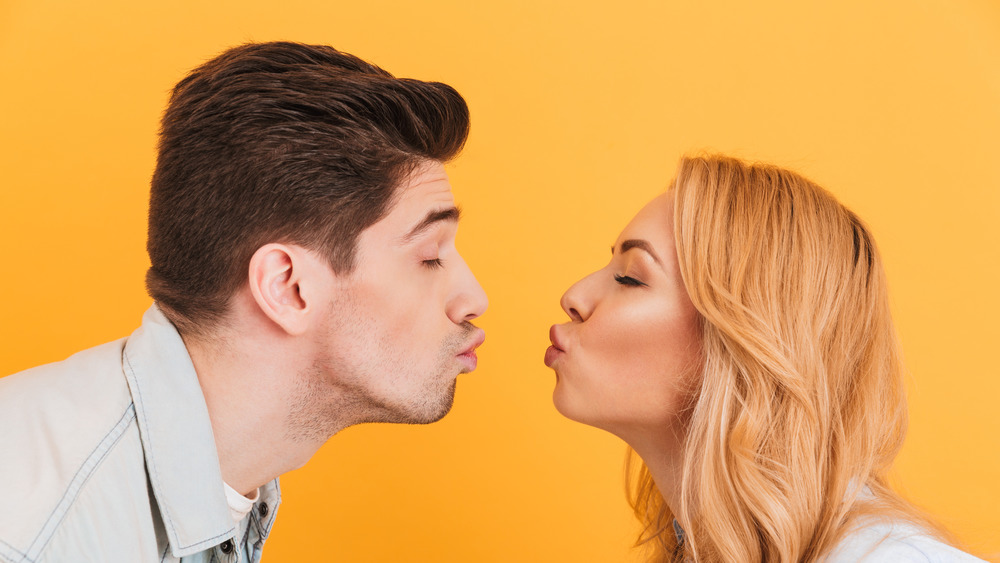 man and woman kissing 