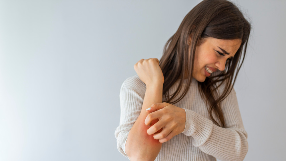 woman scratching itch