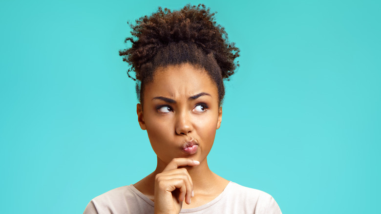 A woman arching her eyebrow