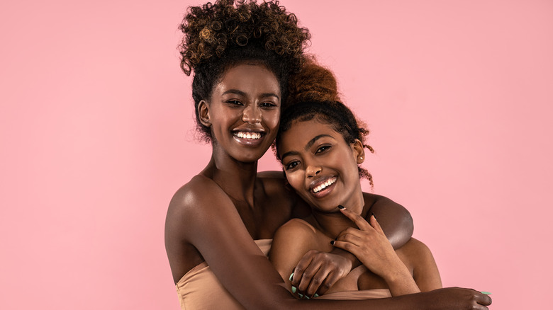 Two women hugging and smiling