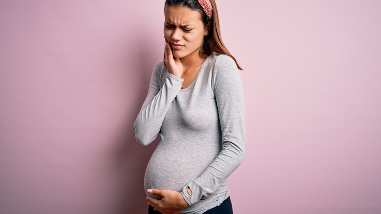 Pregnant woman holding her belly