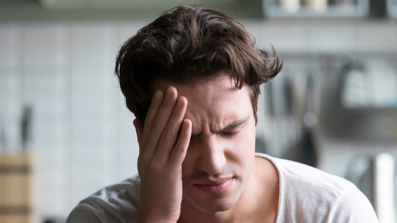 young man feeling nauseous