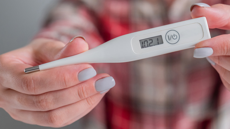 Woman holding thermometer 