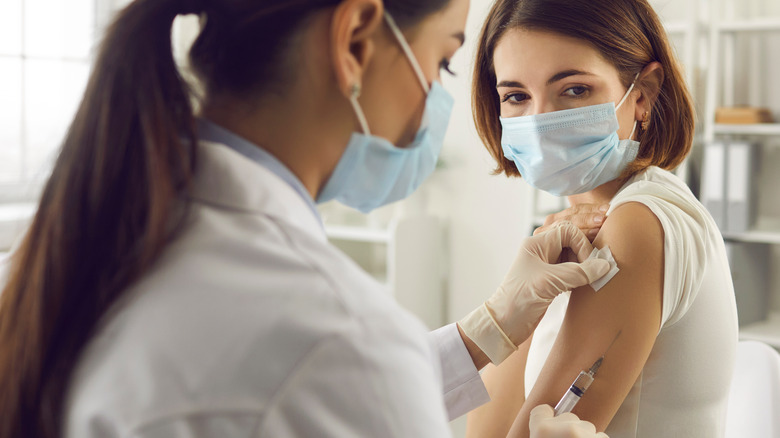 Woman receiving a flu shot from a doctor