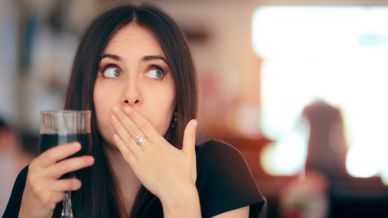 Woman covering her mouth with her hand