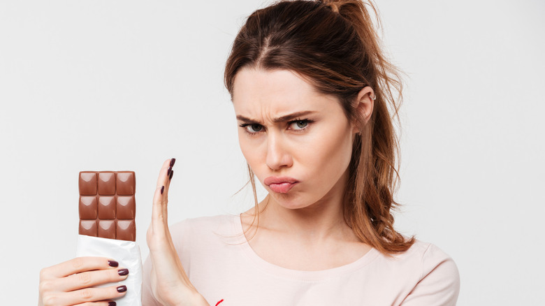 woman saying no to chocolate bar