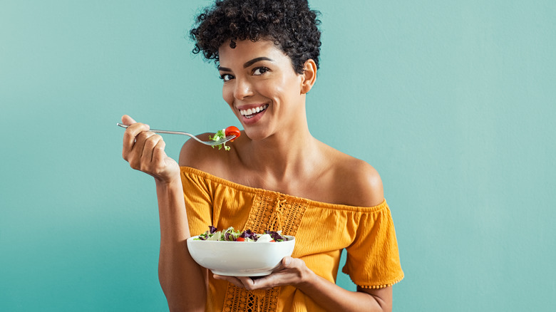 African American woman eating salad