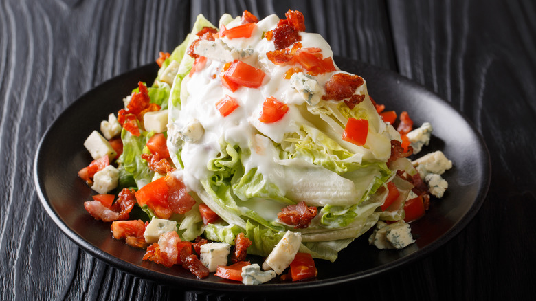 wedge salad on black table