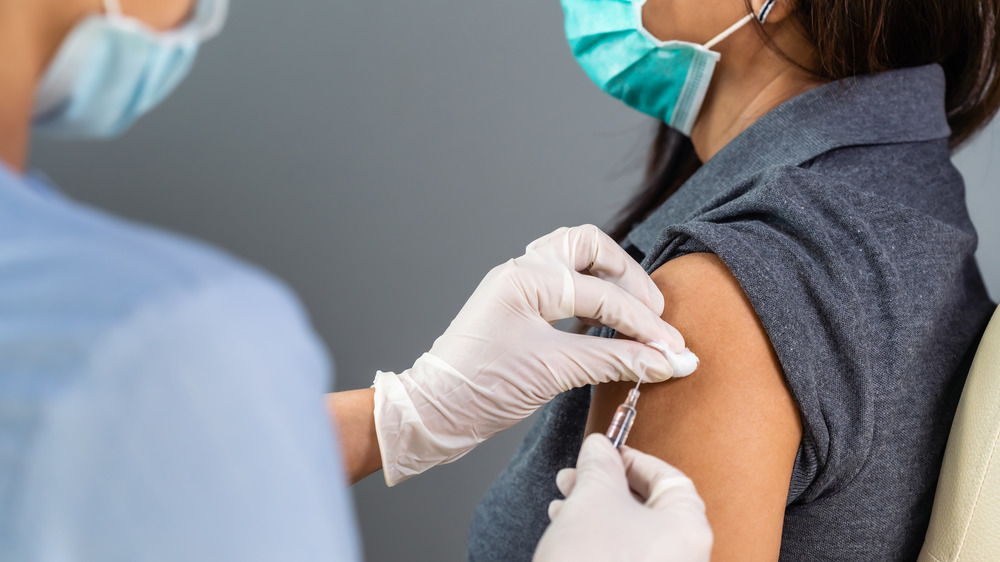 person getting vaccine wearing mask