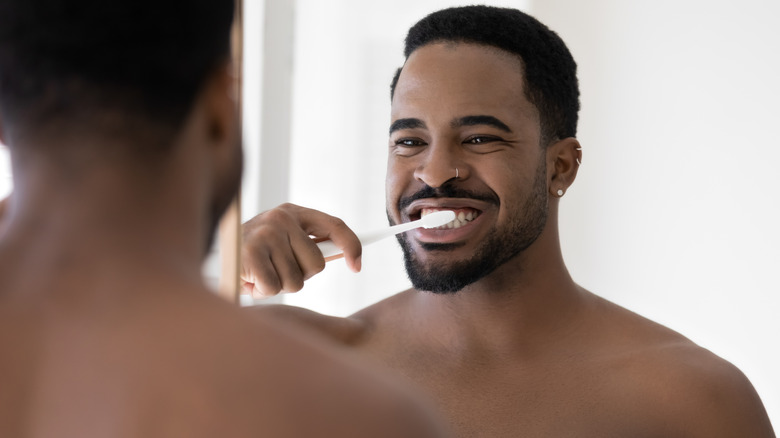 man brushing teeth