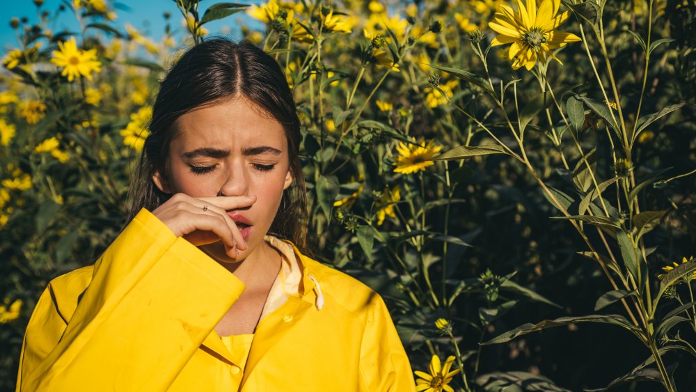 Woman next to flowers