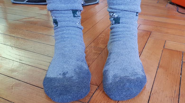 Two feet with sweaty blue socks