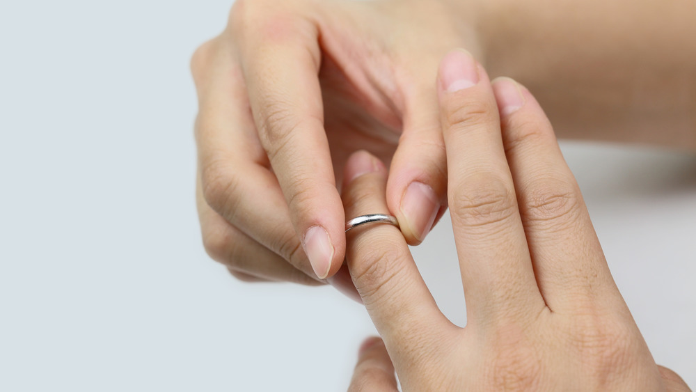 woman trying to take off ring