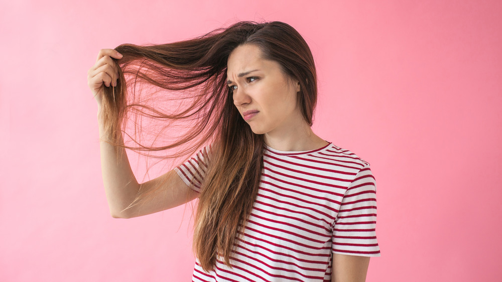 Girl looking at her hair