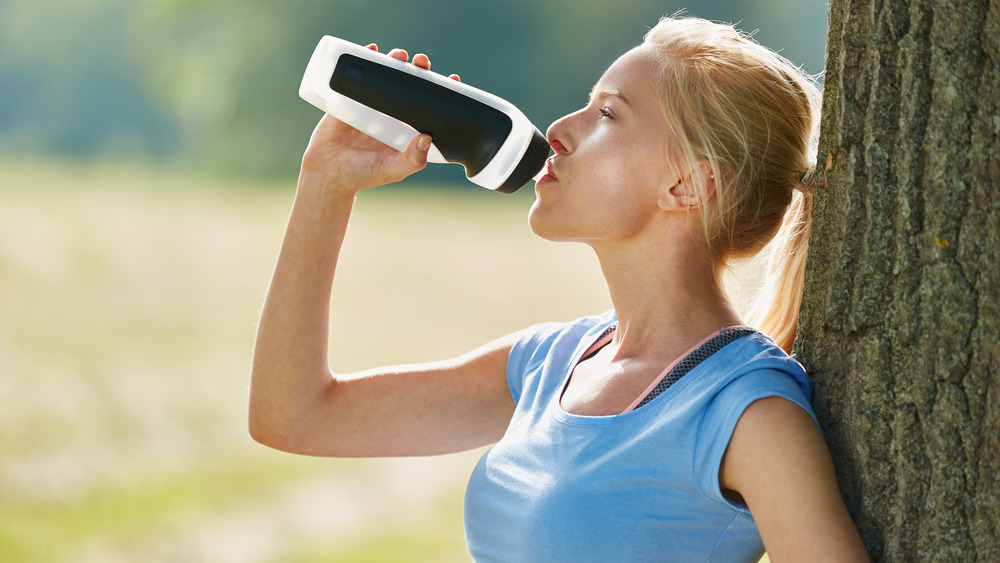 Woman drinking from water bottle