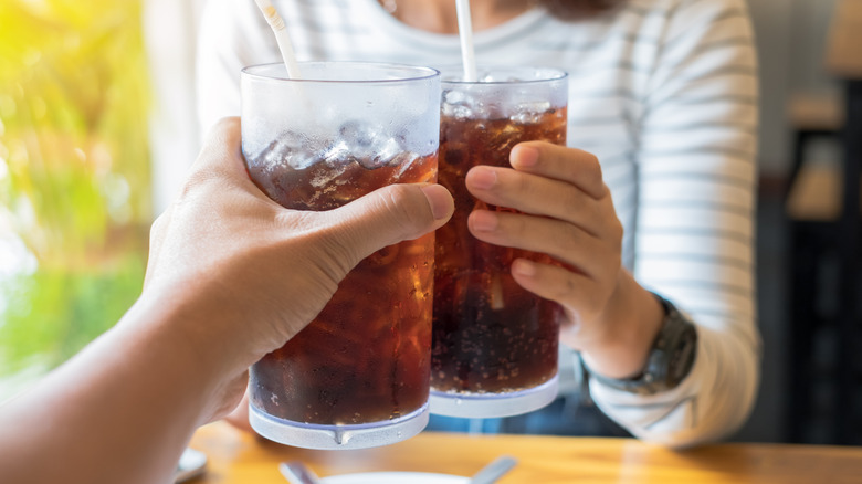 toasting with soda glasses