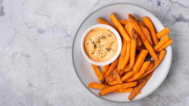 a plate of sweet potato fries and a sauce