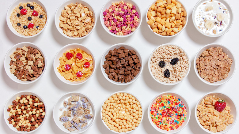 Several bowls of cereal set against a white background