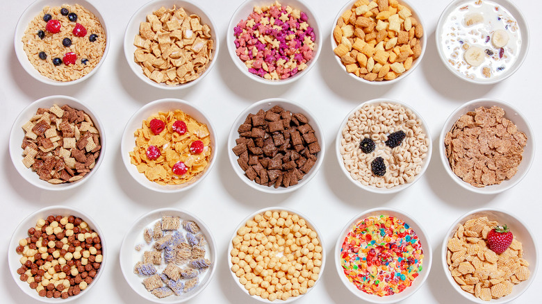 Several bowls of cereal set against a white background