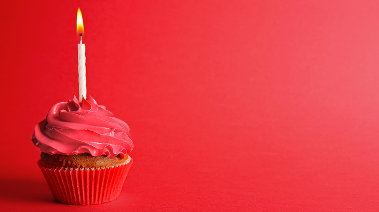 cupcake with red icing and birthday candle