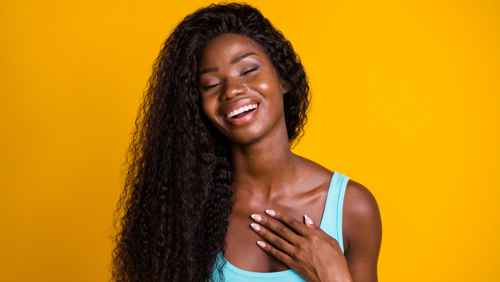 Woman sighing and smiling with her hand on her chest