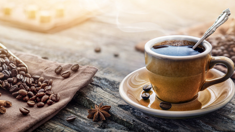 Cup of coffee with coffee beans 