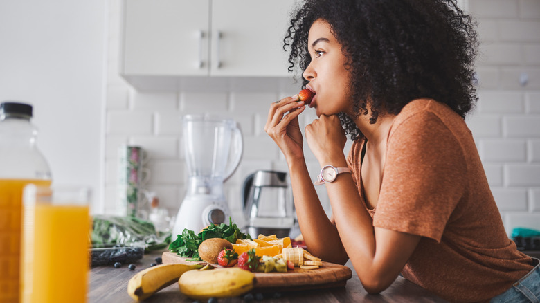Woman eating fruit