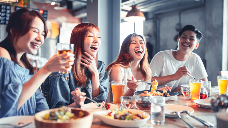 A group of friends eating at a restaurant